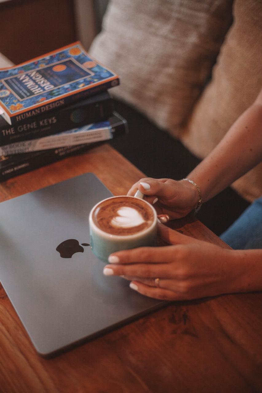 Cafea și cărțile Human Design pe laptop